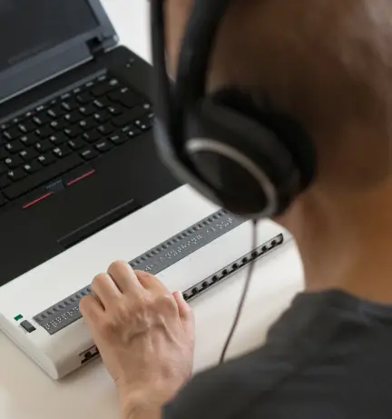 Man using a braille keyboard.